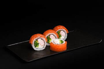 Delicious Fresh Salmon Sushi Rolls Presenting Exquisitely on a Black Background