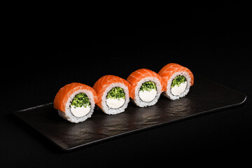 Delicious Fresh Salmon Sushi Rolls Presenting Exquisitely on a Black Background