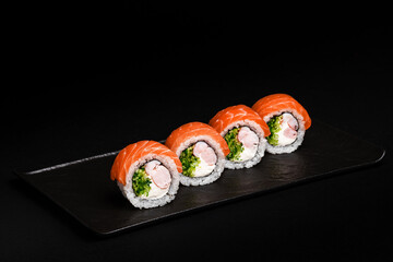Delicious Fresh Salmon Sushi Rolls Presenting Exquisitely on a Black Background