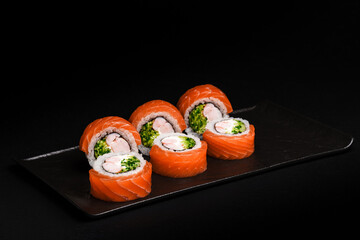 Delicious Fresh Salmon Sushi Rolls Presenting Exquisitely on a Black Background