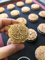 Delicious Handmade Mooncakes Being Prepared in a Cozy Kitchen Setting During the Mid-Autumn Festival Celebration