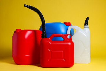 Many different plastic canisters on yellow background