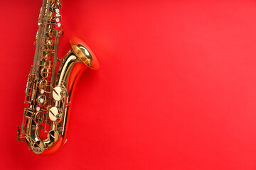 Jazz. One beautiful saxophone on red background, space for text