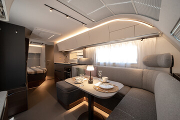 ANKARA,TR-AUGUST 20,2024:Interior with,tables,refrigerator,kitchen corners,ceiling ligthning,couches,living space in modern Adria Alpina 583 LP.
