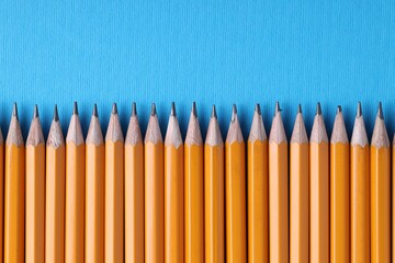 Many pencils on light blue background, top view. Space for text