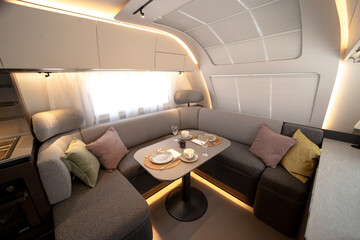 ANKARA,TR-AUGUST 20,2024:Interior with,tables,refrigerator,kitchen corners,ceiling ligthning,couches,living space in modern Adria Alpina 583 LP.