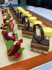 An exquisite arrangement of bakery products, including colorful macarons and intricate desserts, highlights the artistry of a pastry chef