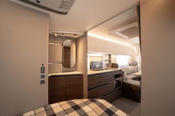 ANKARA,TR-AUGUST 20,2024:Interior with,tables,refrigerator,kitchen corners,ceiling ligthning,couches,living space in modern Adria Alpina 583 LP.
