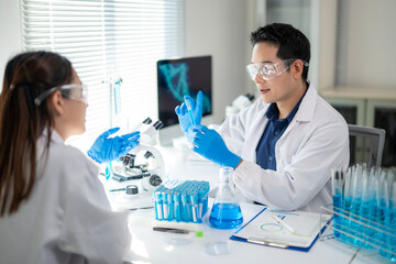 A man and a woman are in a lab