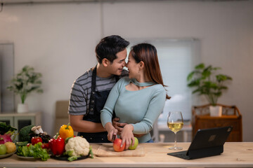 A man and a woman are standing in a kitchen