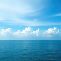 Soft, hazy blue sky with fluffy clouds over calm blue sea, seascape, panorama, weather