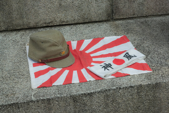 Japanese soldier's military cap, banner with words of kamikaze, and national flag at war time of world war 2 displayed in yasukuni shinto shrine