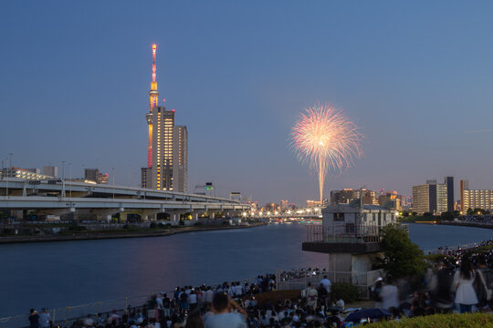 evening scenery of sumida river fireworks festival 2023 with tokyo sky tree seen from shioiri park in minami-senju, arakawa city