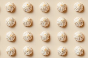 Dumplings arranged in a repeating pattern on a light beige background