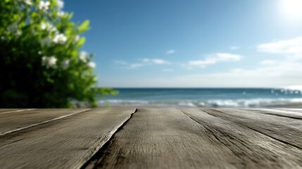 Rustic wooden deck overlooking a tranquil beach scene.  A sunny day with lush greenery and gentle waves