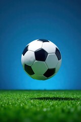 Football ball suspended in mid-air within the cut-out of a football field on blue background, field, stadium