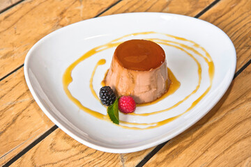 Hazelnut flan, flan with red berries topped with caramel sauce, hazelnut pudding