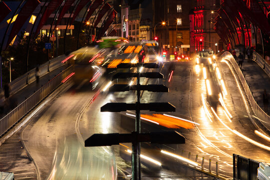 City traffic movement across the Victoria Bridge in Brisbane on a wet evening.