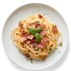 Delicious plate of al dente spaghetti with creamy sauce, bacon, parmesan, and fresh basil on white plate. View from above.