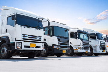 Row of Semi Trucks Parked on The Parking Lot. Big Rig, Tractor Truck. Shipping Cargo Container Trucks at The Port. Economy Business Transport on Road. Trucking. Freight Logistics Truck Transportation.