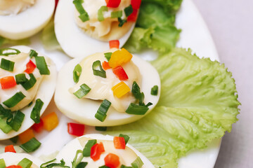 Hard boiled eggs with chives and paprika.Egss with mayo background. Simple and delicious dish for breakfast. Lunch snack idea. Perfect for a nutritious meal with vibrant seasoning.
