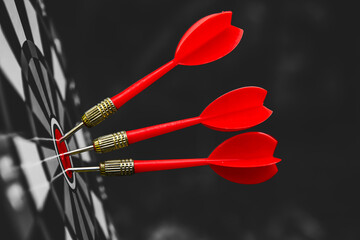 Dark bulls eye target or bullseye have red dart arrows throw hitting challenge the center of a...