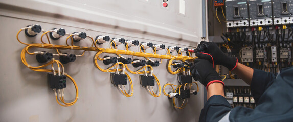 Electrical service technician using electricity checking equipment to check electric current...
