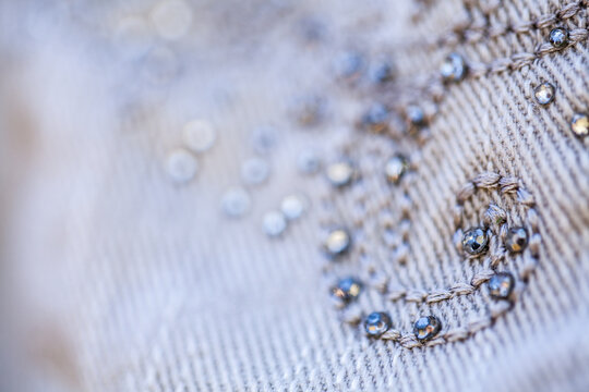 Diamante sparkles and threads making pattern on clothing