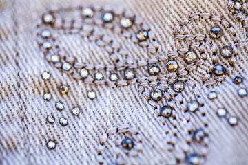 Diamante sparkles and threads making pattern on clothing