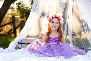 little kid playing imagine game dressed up as princess in purple dress