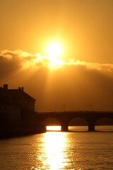 Sunset over bridge and river.