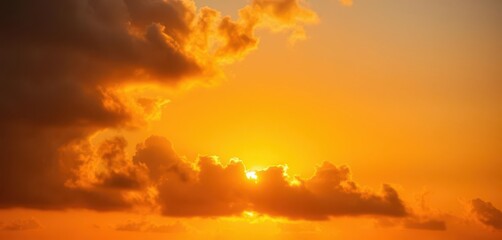 Fototapeta premium Fiery orange sun peeking through thick, dramatic sunset clouds, natural, outdoor, dusk