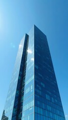 Exterior of glass office building against clear blue sky, business district skyscraper, skyscraper, exterior, corporate