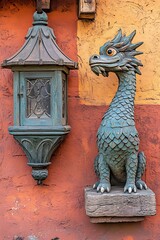 A green dragon statue alongside an antique lantern on the wall