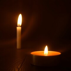 Two candles burning in the dark. (1)