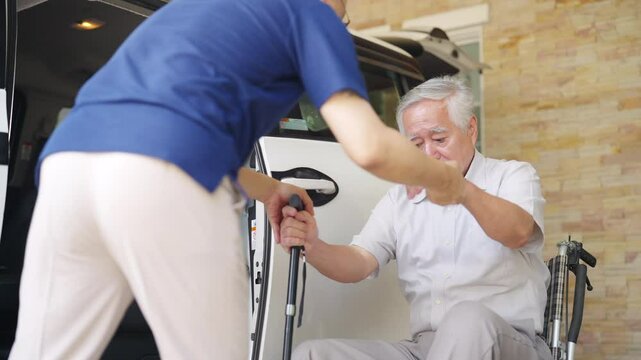 Asian man caregiver or taxi driver helping senior man patient get in the car to get to medical appointments or healthcare therapy sessions at hospital. Assisted elderly patient transportation services