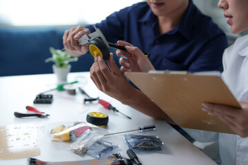 Engineers measuring components for a robotics project