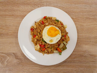 fried rice with fried egg on wooden table, Top View