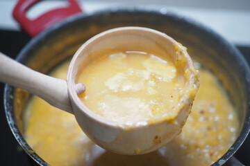 Delicious homemade soup being served from a pot