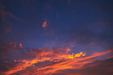 Stunning dramatic sunset sky with purple clouds and pink and red firmament texture