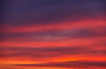 Stunning dramatic sunset sky with purple clouds and pink and red firmament texture banner