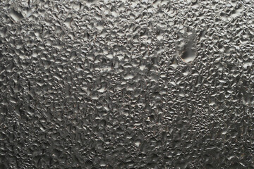 Close-up view of raindrops on a window during a rainstorm