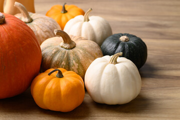 Various pumpkins on wooden background