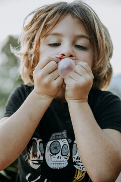 Boy learning to blow bubbles