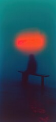 Obraz premium Silhouetted figure on bench against vibrant backdrop