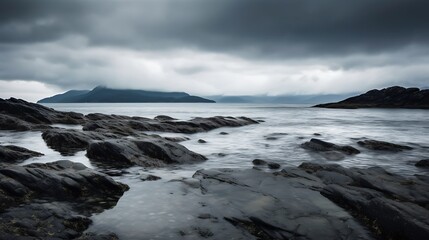 Dark Rocks Meet Calm Sea Under Stormy Skies