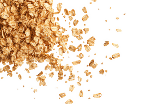 A top view of scattered oat flakes on a black background with some flakes clustered together