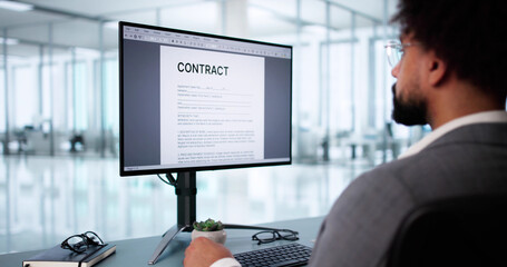 Young African American man carefully reads insurance contract