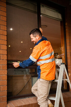 Tradie replacing screen of home window