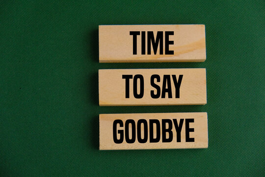 TIME TO SAY GOODBYE is written on a notepad on an office desk with office accessories 